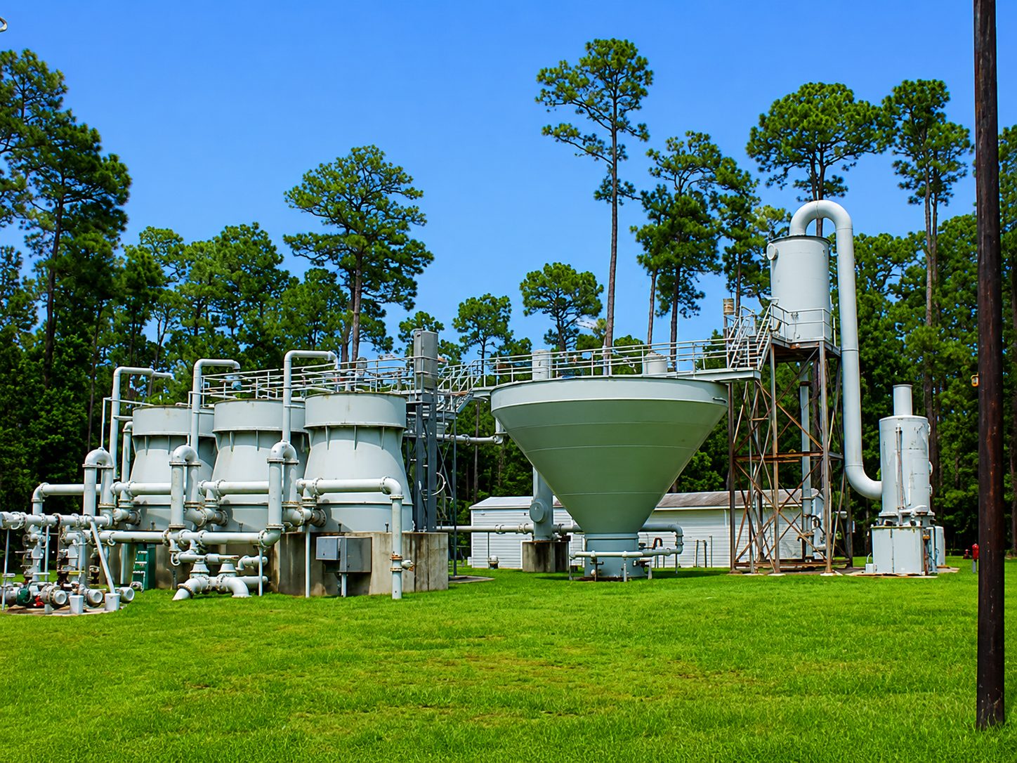 Large outdoor water treatment plant with filtration tanks and trees